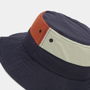 Detail of multi-color waterproof fishing hat with breathable metal eyelets and stitching