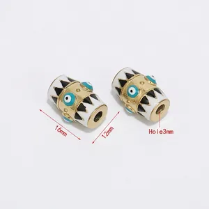 Detailed view of 16mm gold hex beads with enamel evil eye pattern and 3mm aperture