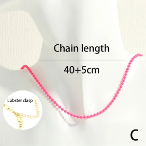 Pink beaded necklace detail showing adjustable lobster clasp and extension chain