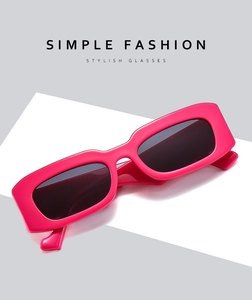 Close-up of hot pink rectangle sunglasses with wide frames on a minimalist background