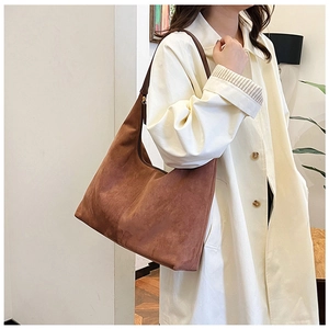Brown frosted large capacity tote bag shown from side profile on shoulder