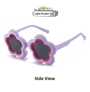 Detail view of flower-shaped kids sunglasses in light purple matte frame with grey lenses