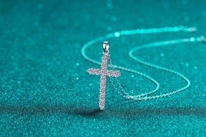 Macro shot of S925 sterling silver cross pendant necklace with moissanite stones