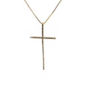 Macro shot of gold-plated cross pendant featuring inlaid colorful zircon crystals
