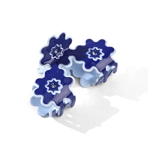 Set of three blue flower hair claws with rhinestones on a clean white background