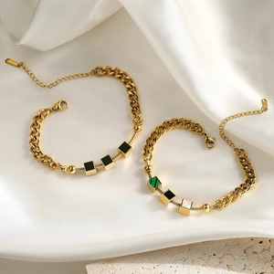 Luxurious gold stainless steel bracelet with shell pendants and snake chain on marble