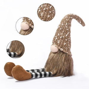 Detail showing knitted texture, plush beard and striped legs of Christmas gnome doll