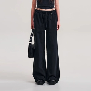 Detail of black cotton wide-leg sports pants with drawstring waist and cross pattern