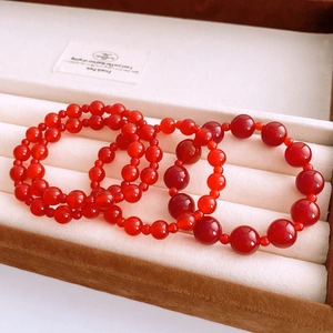 Macro shot of vintage red agate beaded bracelets with multiple sizes in a jewelry box
