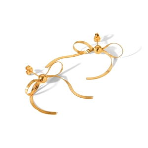 Macro shot of 18k gold butterfly bow stud earrings with flowing snake chain tassels