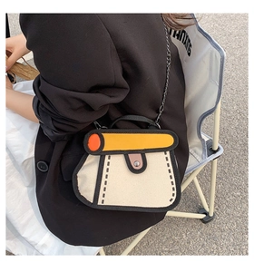 Model wearing a 2D cartoon style canvas crossbody bag with yellow flap and chain strap