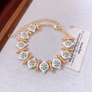 Detailed macro view of vintage gold bracelet with white enamel and amber gemstones