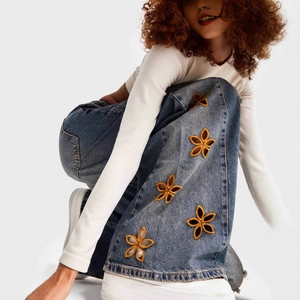 Women's high waist wide leg blue denim jeans featuring yellow floral side embroidery