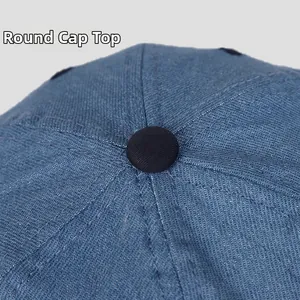 Macro detail of the round crown and stitched denim panels on the baseball cap