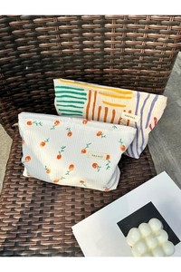 Detailed texture of corduroy cosmetic bags with floral patterns and sturdy zippers