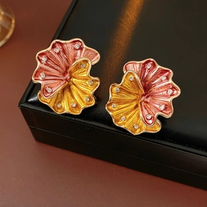 Detailed macro view of vintage floral earrings with pink yellow gradient and crystals