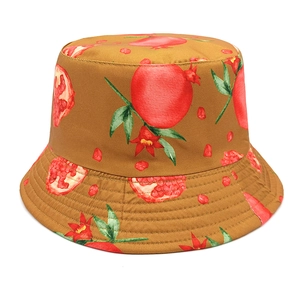 Detailed close-up of pomegranate print on cotton bucket hat with vibrant fruit patterns