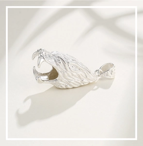 Detail of silver wolf head pendant with fine fur textures and carved details