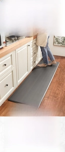 Macro detail of anti-fatigue kitchen mat showing waterproof PU surface and rebound texture