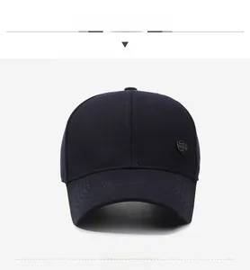 Front view detail of navy blue baseball cap with metal shield logo and stitched brim