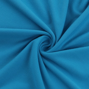 Macro shot of blue knit fabric texture showing soft pleats and elastic material