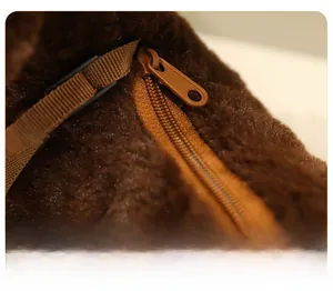 Close-up of smooth zipper closure and durable woven strap on brown plush dog bag