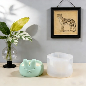 DIY Easter bunny candle resin mold set with a mint green rabbit sculpture on a desk