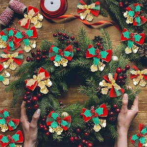 Macro shot of festive red and green plaid Christmas bows with golden bells on wreath