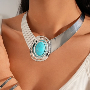Detail of silver necklace with asymmetric metal band and blue turquoise oval gemstone