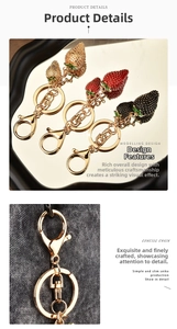 Detailed macro view of strawberry keychains featuring rhinestones and gold lobster clasps