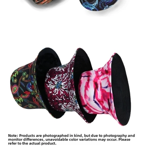 Detail shot of various bucket hats with red tie-dye and tropical floral patterns on white background