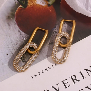 Detailed shot of gold-plated chain-link earrings with micro-pave white cubic zirconia