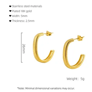 Detail of 18K gold-plated C-shape stainless steel earrings with ribbed texture and 26mm size