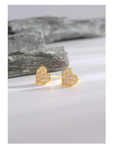 Close-up of gold heart stud earrings featuring sparkling white zircon micro-pave setting