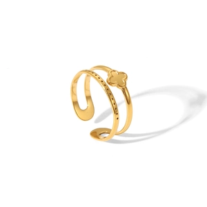 Macro detail of a double-layered gold stainless steel ring with hollow clover pattern