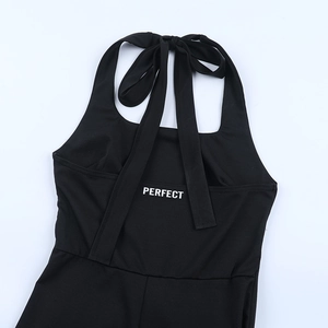 Back view of black halter jumpsuit with 'PERFECT' print and tie-up strap detail