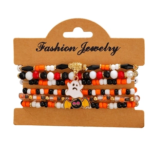 Close-up of Halloween beaded bracelet set with ghost and bat charms on card