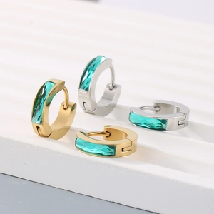 Minimalist gold and silver hoop earrings with rectangular emerald green cubic zirconia