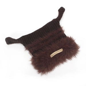 Detailed close-up of knitted cat-ear beanie with brown faux fur trim and metal logo