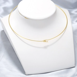 Elegant gold minimalist stainless steel choker necklace displayed on a white stand