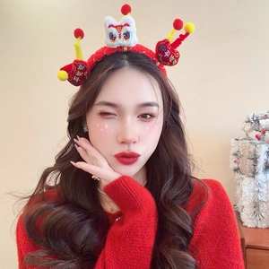 Detail of red plush Lunar New Year headband with festive lion dance decor and charms
