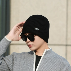 Classic black ribbed knit beanie for men with brand label on fold, winter thermal style