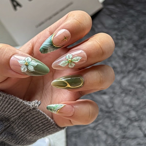 Emerald green almond press-on nails with 3D embossed flowers and gold foil marble art