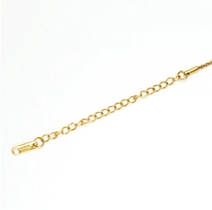 Detail of a gold-plated stainless steel anklet extension chain with a 585 hallmark tag