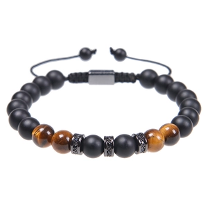 Detailed shot of matte black beads and tiger eye stones with zircon metal spacers