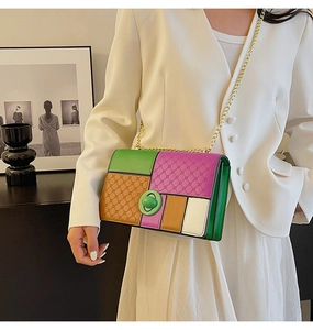 Detail of color-block crossbody bag with diamond embossed leather and gold chain strap
