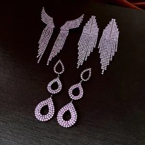 Elegant silver tassel earrings set with pink rhinestones in teardrop and wing designs