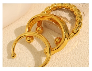 Close-up of high-polish 18K gold plated minimalist beaded ring and ball open bangles