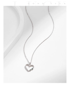 Detail of s925 silver heart necklace with infinity symbol and pave cubic zirconia stones