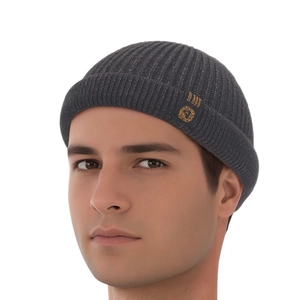 Close-up of ribbed dark grey brimless docker hat with a premium woven label detail